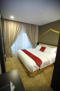 Postel nebo postele na pokoji v ubytování Al Khatiri Hotel