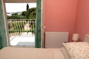 a bedroom with a bed and a balcony at Apartman Dinka in Trogir