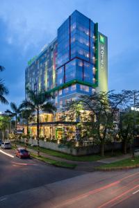 a large glass building with a street in front of it at ibis Styles Cikarang in Cikarang