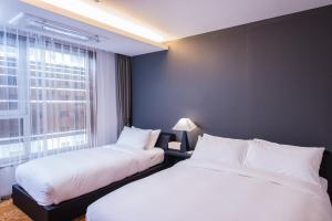 Postel nebo postele na pokoji v ubytování Hotel Leo