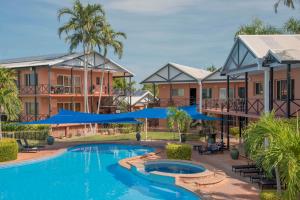 
a large swimming pool in a residential area at Moonlight Bay Suites in Broome
