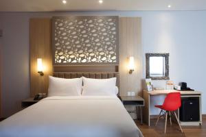 A bed or beds in a room at ibis Styles Cikarang