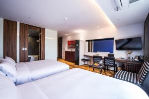 Postel nebo postele na pokoji v ubytování Hotel Leo