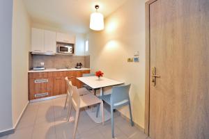 a kitchen and dining room with a table and chairs at Astron Suites & Apartments in Kos