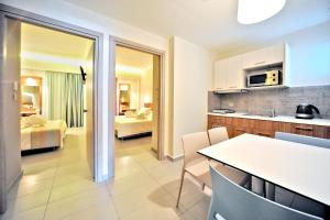 a room with a kitchen and a living room at Astron Suites & Apartments in Kos