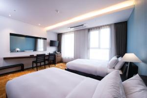 Postel nebo postele na pokoji v ubytování Hotel Leo