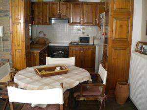 a small kitchen with a table and a stove at Marelmy in Mouresi