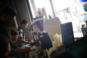 a group of people working in a coffee shop at Borough Capsule Hostel Bali in Legian