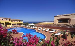 a resort with a swimming pool and lounge chairs and flowers at Hotel Stelle Marine in Cannigione