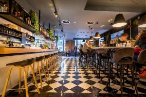 a restaurant with a black and white checkered floor at Hotel Die Port van Cleve in Amsterdam