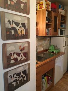 a kitchen with pictures of cows on the wall at Residence Redicervinia in Breuil-Cervinia