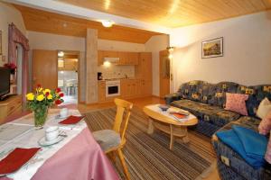 a living room with a couch and a table at Berghof Pension und Ferienwohnungen in Bischofsmais