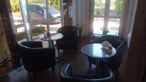 a restaurant with tables and chairs and a window at Il Mirto E La Rosa in Arenella