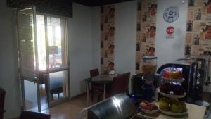 a kitchen with a table and a table with fruit on it at Il Mirto E La Rosa in Arenella