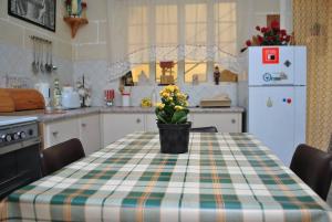 a kitchen with a table with a vase of flowers on it at St Nicholas Crt in Munxar