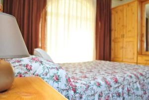 a bedroom with a bed and a lamp on a table at St Nicholas Crt in Munxar