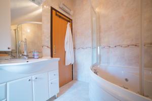 a bathroom with a sink and a tub and a shower at Apartment Aldo in Omiš +32 photos