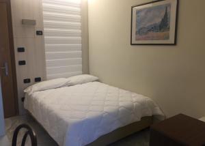 Postel nebo postele na pokoji v ubytování Hotel Consuelo