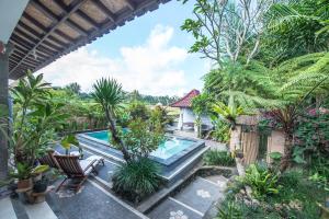 an image of a swimming pool in a garden at Pondok Anastasia in Ubud