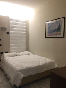 Postel nebo postele na pokoji v ubytování Hotel Consuelo