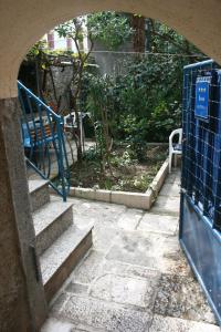 an entrance to a garden with a blue gate and stairs at House Markovina in Cres