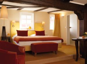 a hotel room with a large bed and a large window at Hotel Die Sonne Frankenberg in Frankenberg