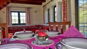 a table with a pink table cloth on top at Apartment Holiday - River view beside Pyramid in Visoko +14 photos