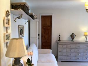 a living room with a white couch and a dresser at Margot House by Holiday World in Limone Piemonte