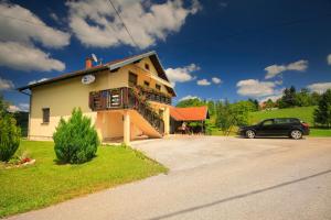 ein Haus mit einem davor geparkt in der Unterkunft Apartments Sabljak in Rakovica