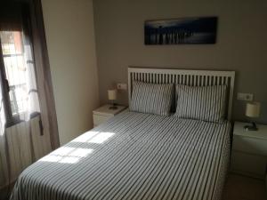 Łóżko lub łóżka w pokoju w obiekcie APARTAMENTOS POBRA-CASTELO
