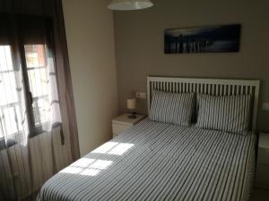 Łóżko lub łóżka w pokoju w obiekcie APARTAMENTOS POBRA-CASTELO
