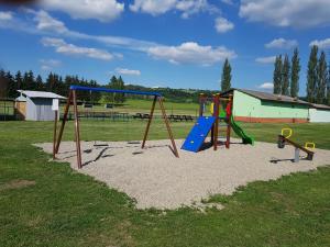a playground with two play equipment in a field at Guest House Sherpa in Moravská Třebová