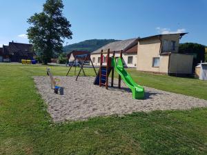 a playground with a slide and a swing set at Guest House Sherpa in Moravská Třebová