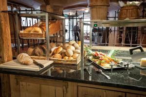 a counter with baskets of bread and baskets of vegetables at Berghotel Trübsee in Engelberg