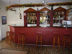 a red brick bar with stools in front of it at Hotel Markos in Ierissos