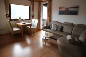 a living room with a couch and a table at Gästehaus Preuss in Ellenz-Poltersdorf