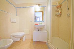 a bathroom with a toilet and a sink and a shower at DolceVita Apartments N 382 in Venice
