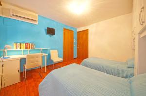 a bedroom with two beds and a desk with a desk at DolceVita Apartments N 382 in Venice