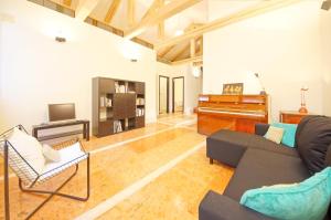 a living room with a couch and a piano at DolceVita Apartments N 181 in Venice