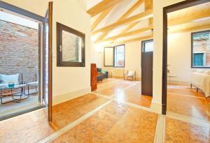 an open living room with a brick wall at DolceVita Apartments N 181 in Venice