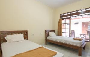 Postel nebo postele na pokoji v ubytování Pondok Nuri Homestay