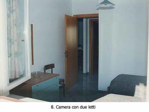 1 dormitorio con tocador, cama y escritorio en Appartamento a pochi passi dal mare en Canneto