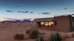a building in the middle of the desert at Sossusvlei Lodge in Sesriem