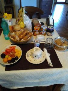 a table with a breakfast of bread and food on it at Daddos in Flumini di Quartu +16 photos