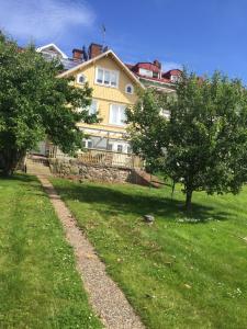 a large yellow house with trees in front of it at Brahe 65 in Gränna