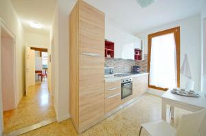 a kitchen with a large wooden cabinet in a room at DolceVita Apartments N 372 in Venice