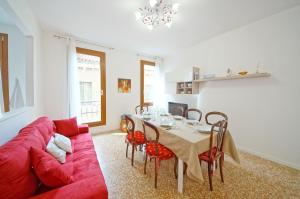 a living room with a red couch and a table at DolceVita Apartments N 372 in Venice