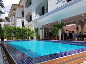 a swimming pool in front of a building at Smiley's Guesthouse in Siem Reap
