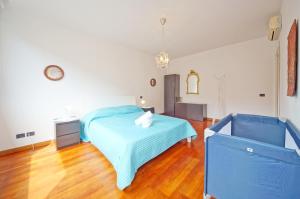 a bedroom with a blue bed and a wooden floor at DolceVita Apartments N 329 in Venice