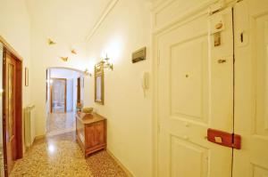 a hallway with a white door and a table at DolceVita Apartments N 331 in Venice